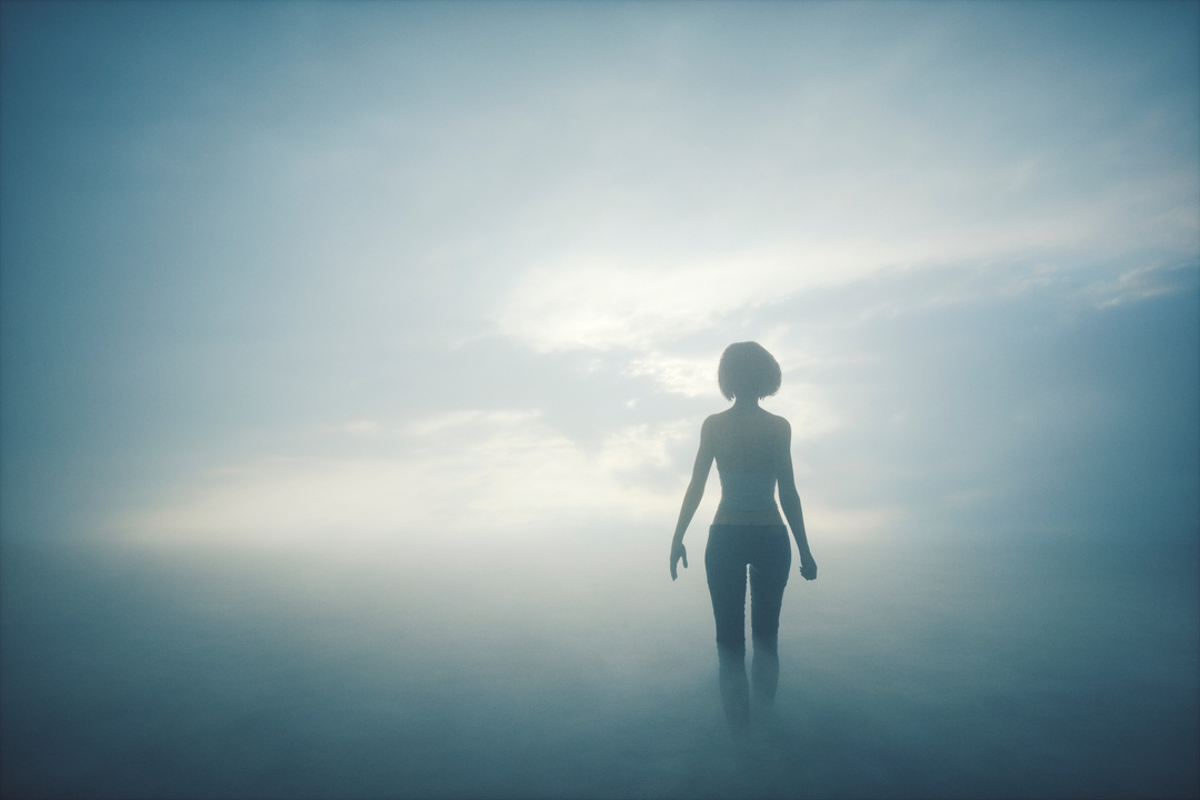Woman walking into the fog